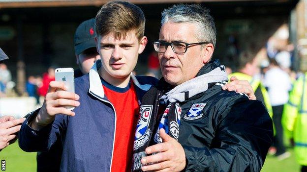 A fan takes a selfie with Ayr United manager Ian McCall