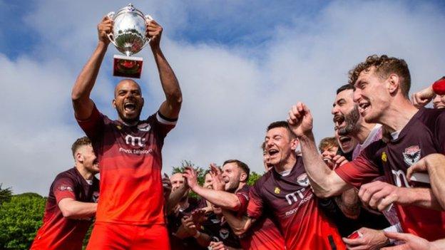 Furo Davies holding the cup with the Ravens team