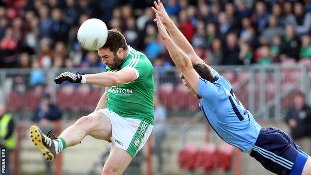 Cargin's Micheal Magill unleashes his shot but the ball has to get past the block from Emmett McFadden of Killyclogher