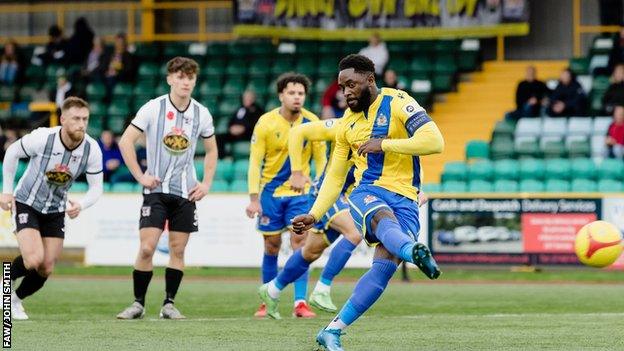 Kayne McLaggon scores from the spot for Barry against Cefn Druids