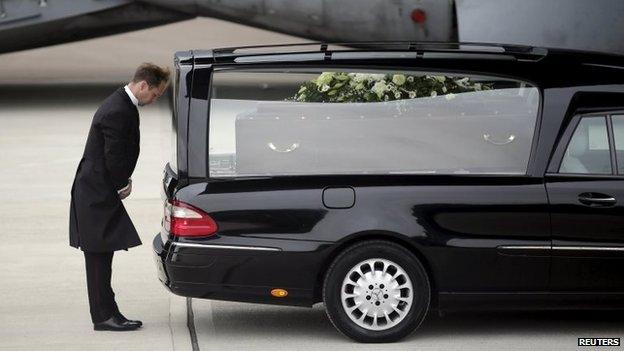 The coffin of Ann McQuire placed in a hearse