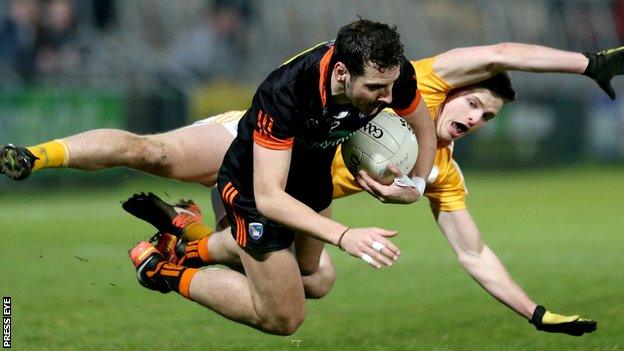 Armagh forward Jamie Clarke and Antrim's Conor Hamill take a tumble at the Athletic Grounds