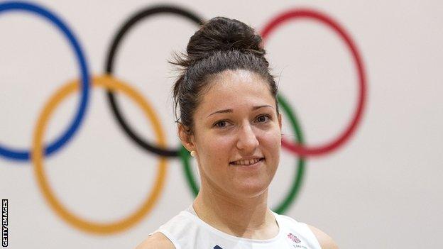 Natalie Powell poses in front of the Olympic rings