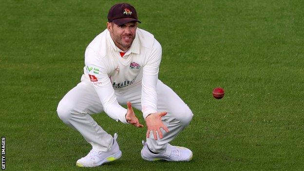 Jimmy Anderson takes a catch to remove Glamorgan's Kiran Carlson