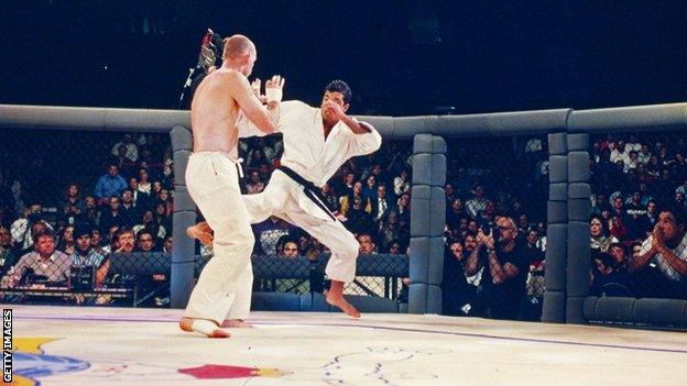 A fighter aims a leg kick at another