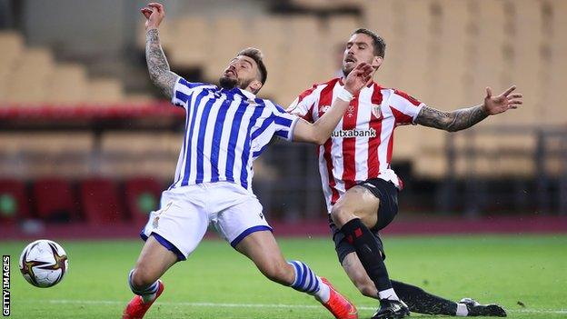 Inigo Martinez of Athletic Bilbao fouls Real Sociedad's Portu