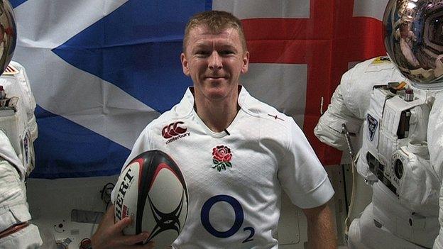 Tim Peake wearing an England shirt