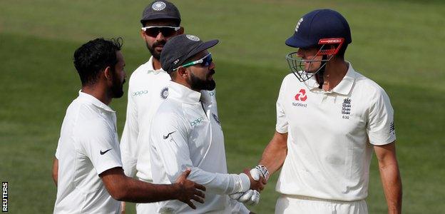 The India players shake hands with Alastair Cook after his dismissal