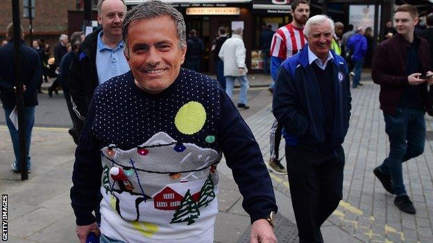 A Chelsea fan wears a Jose Mourinho mask outside Stamford Bridge