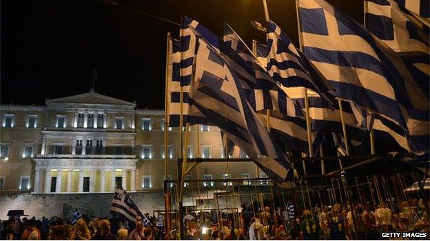 greek flags and demonstrators