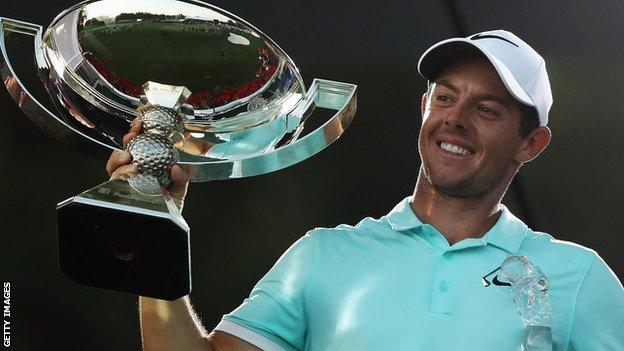 Rory McIlroy celebrates with the FedEx Cup after winning the Tour Championship