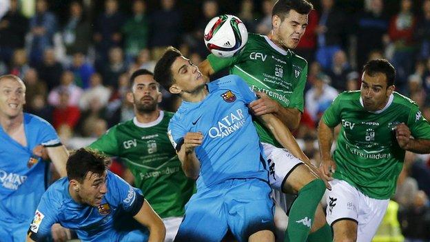 Barcelona's Marc Bartra (centre left) tries to win a heading battle