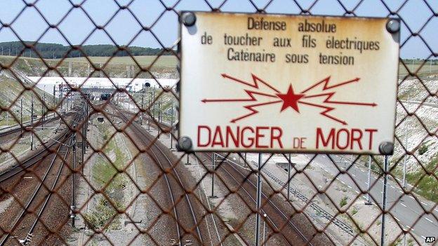 Sign warns about the risk of death on rail tracks ahead of the Channel Tunnel