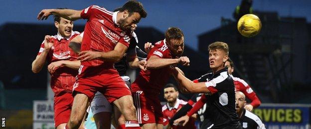 Aberdeen's Andy Considine rose highest to break the deadlock at Dens Park