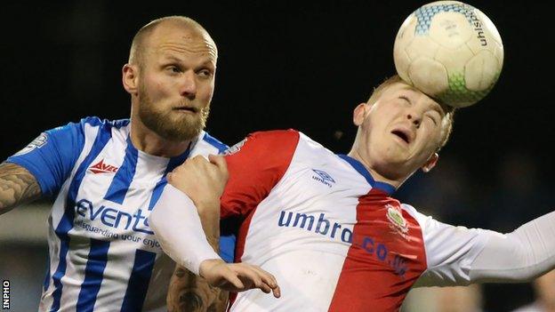 Coleraine's Gareth McConaghie closes in on Linfield striker Shayne Lavery