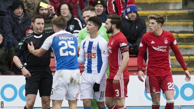 Kilmarnock striker Eamonn Brophy booked by referee Steven McLean against Aberdeen