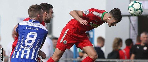 Cliftonville’s Jay Donnelly gets to the ball first in the match at Newry