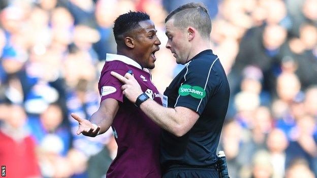 Hearts midfielder Joaquim Adao and referee John Beaton