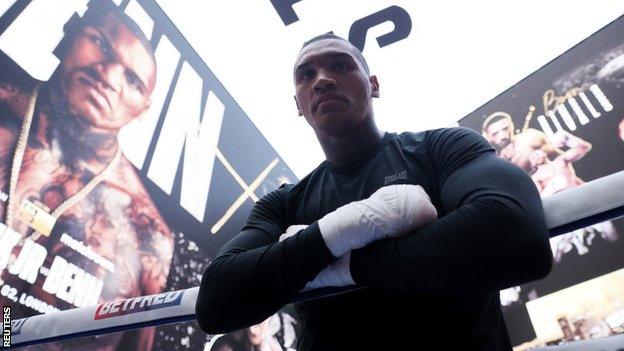 Conor Benn leans over rope