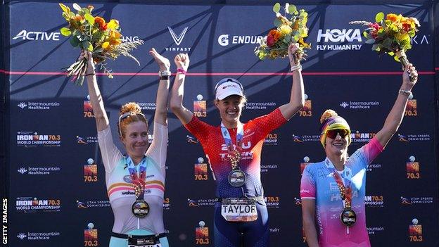 Paula Findlay of Canada in second place, Taylor Knibb of the USA in first place and Emma Pallant-Browne of Britain in third place celebrate on podium