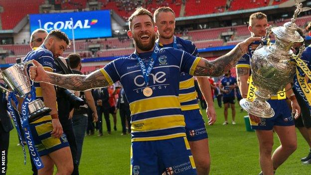 Warrington's Daryl Clark celebrated winning both the Challenge Cup and the Lance Todd Trophy