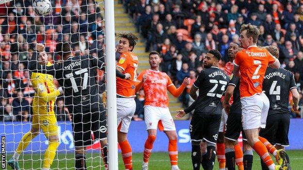 Gary Madine watches his header sail into the net, taking his tally for the season to eight