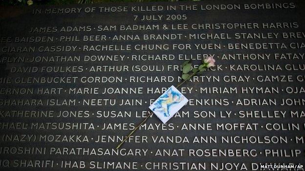 A flower lies on a plaque bearing the names of victims at the 7/7 memorial