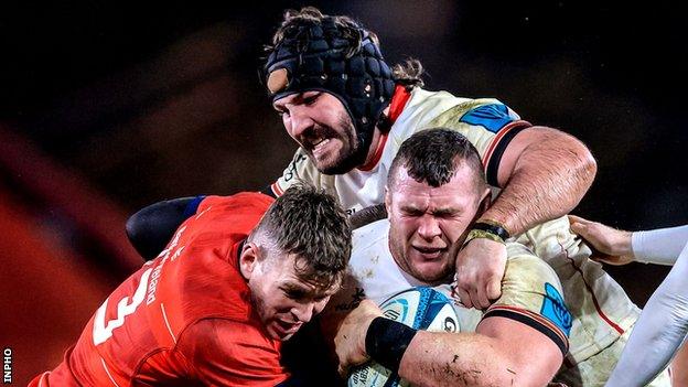 Tom O'Toole and Jack McGrath try and make ground at Thomond Park despite Chris Farrell's efforts