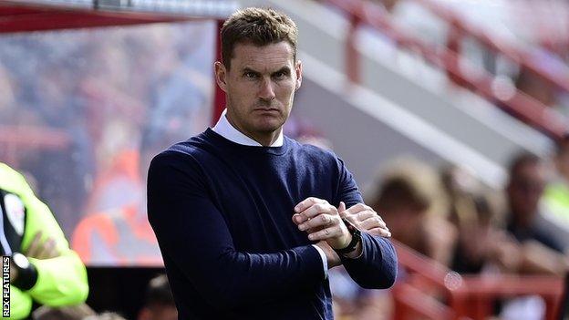 Matt Taylor watches Exeter from the touchline this season