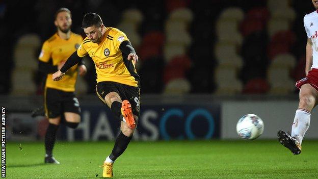 Padraig Amond of Newport County tries a shot at goal