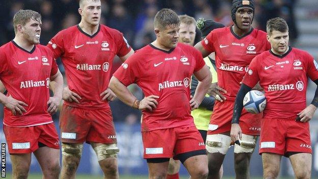 Saracens players as Quins run in another try in their 41-14 victory against the relegated champions