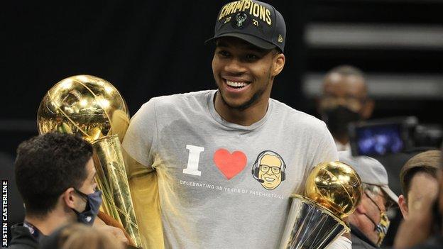 Giannis Antetokounmpo with MVP and NBA championship awards.