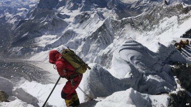 Climber scaling Mount Everest.