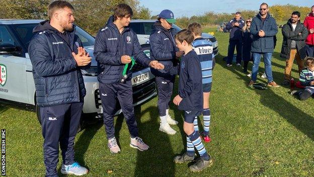 London Irish senior players hand out medals at a community rugby union festival