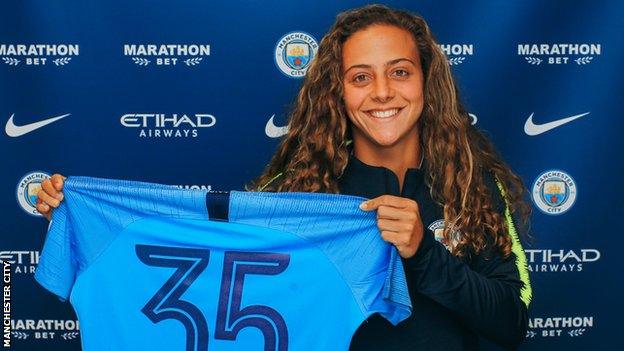 Matilde Fidalgo holds up a Manchester City shirt after joining the WSL side