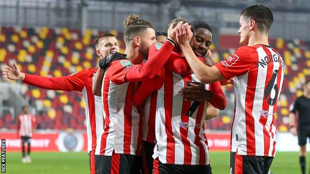 Brentford's players celebrate after scoring against Newcastle United in the quarter-finals of the Carabao Cup