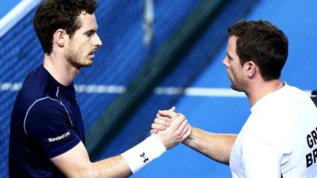 Andy Murray of Great Britain shakes hands with captain Leon Smith