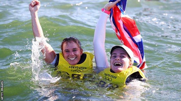 Hannah Mills and Eilidh McIntyre celebrate in the water after jumping in