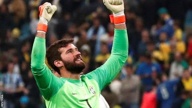 Brazil's Alisson celebrates winning the penalty shootout