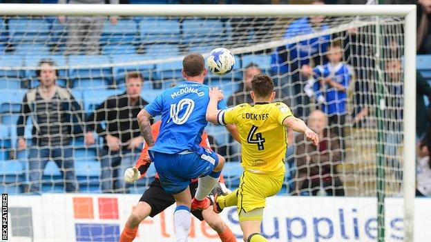 Gillingham's Cody McDonald shooting at goal