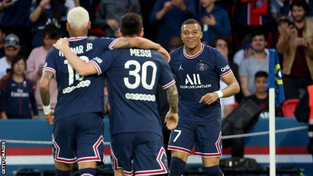 Kylian Mbappe celebrates with Neymar and Lionel Messi