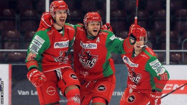 Jake Coughler celebrates with Cardiff Devils team-maes after scoring in a behind closed doors game.