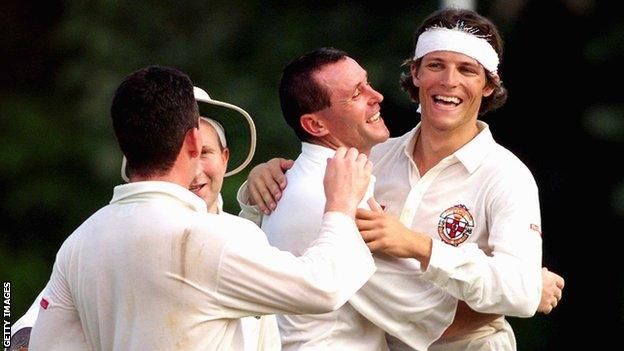 Ryan Eagleson, with a cut up hotel towel as a sweat band, is hugged by Gordon Cooke