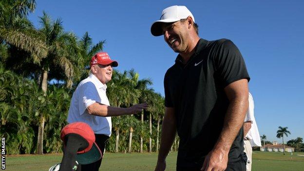 Donald Trump laughing with Brooks Koepka