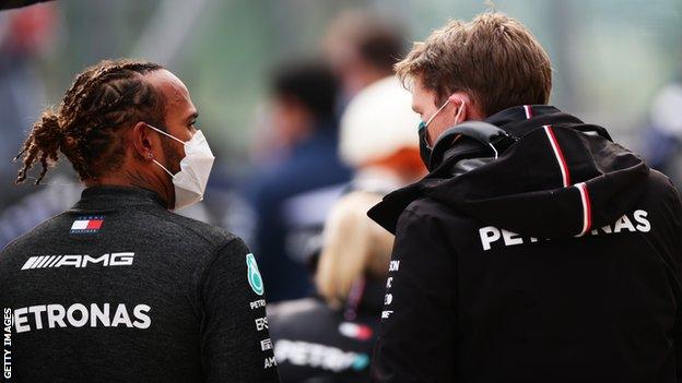 Lewis Hamilton and a Mercedes crew memeber