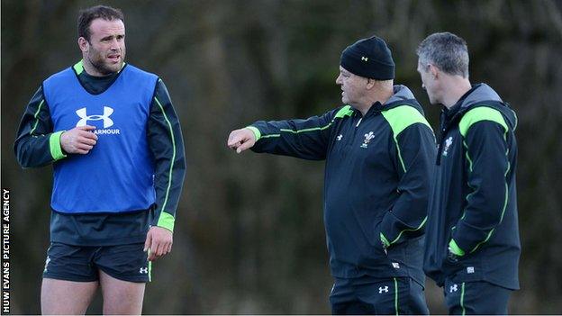 Jamie Roberts receives instructions from Warren Gatland as Rob Howley looks on