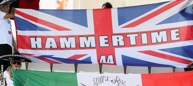 Lewis Hamilton fans hold a 'Hammertime' flag