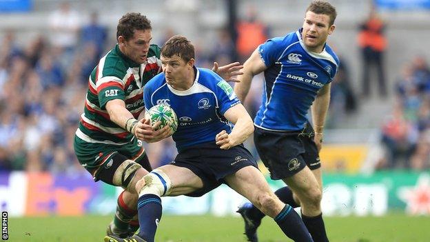 Craig Newby tackles Brian O'Driscoll as Gordon D'Arcy watches on