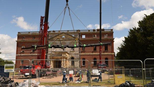 Cranes being used lift timber beams