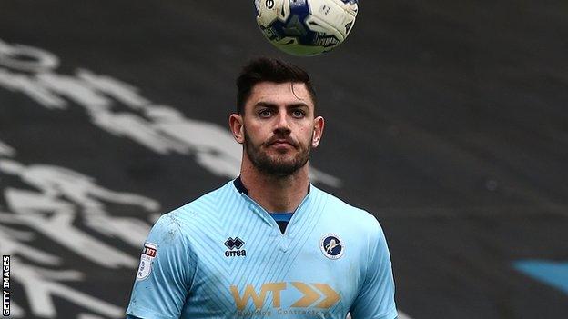 Tom King keeps his eye on the ball during a Millwall match